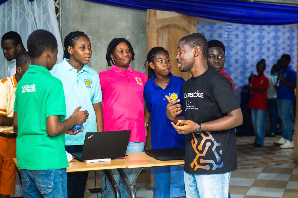 A Coasted Code instructor in conversation with two students