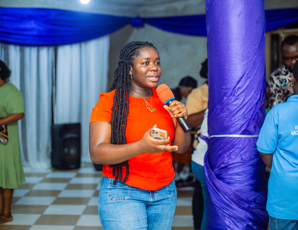 A Coasted Code facilitator speaking with a microphone at a school event